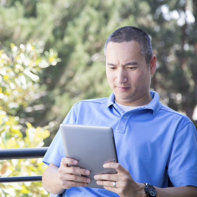 Father reading on a tablet.